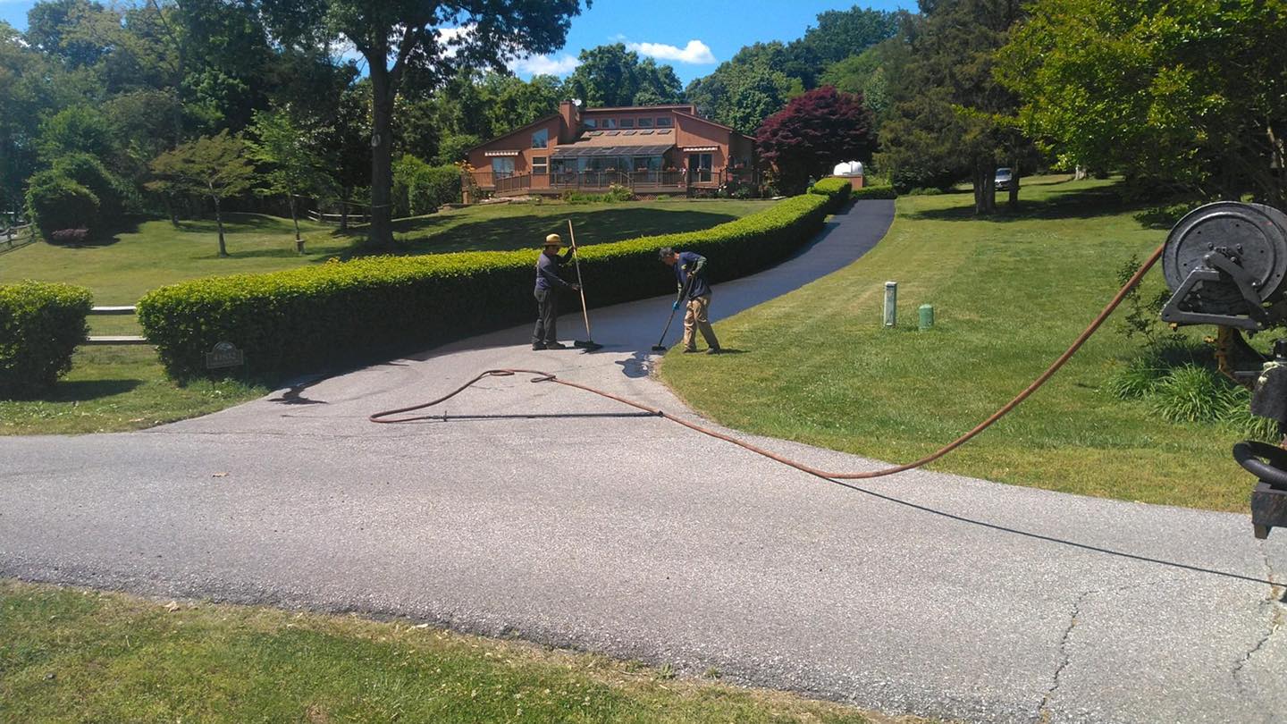 Men Seal Coating on the Driveway